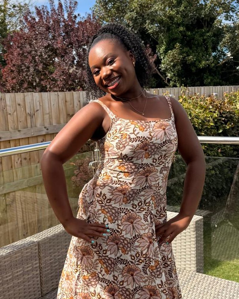 Abi, founder of Derica Solutions, smiling in a garden